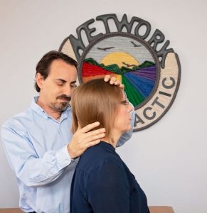 Dr. Barry Weinberg palpating the neck during a NetworkSpinal adjustment